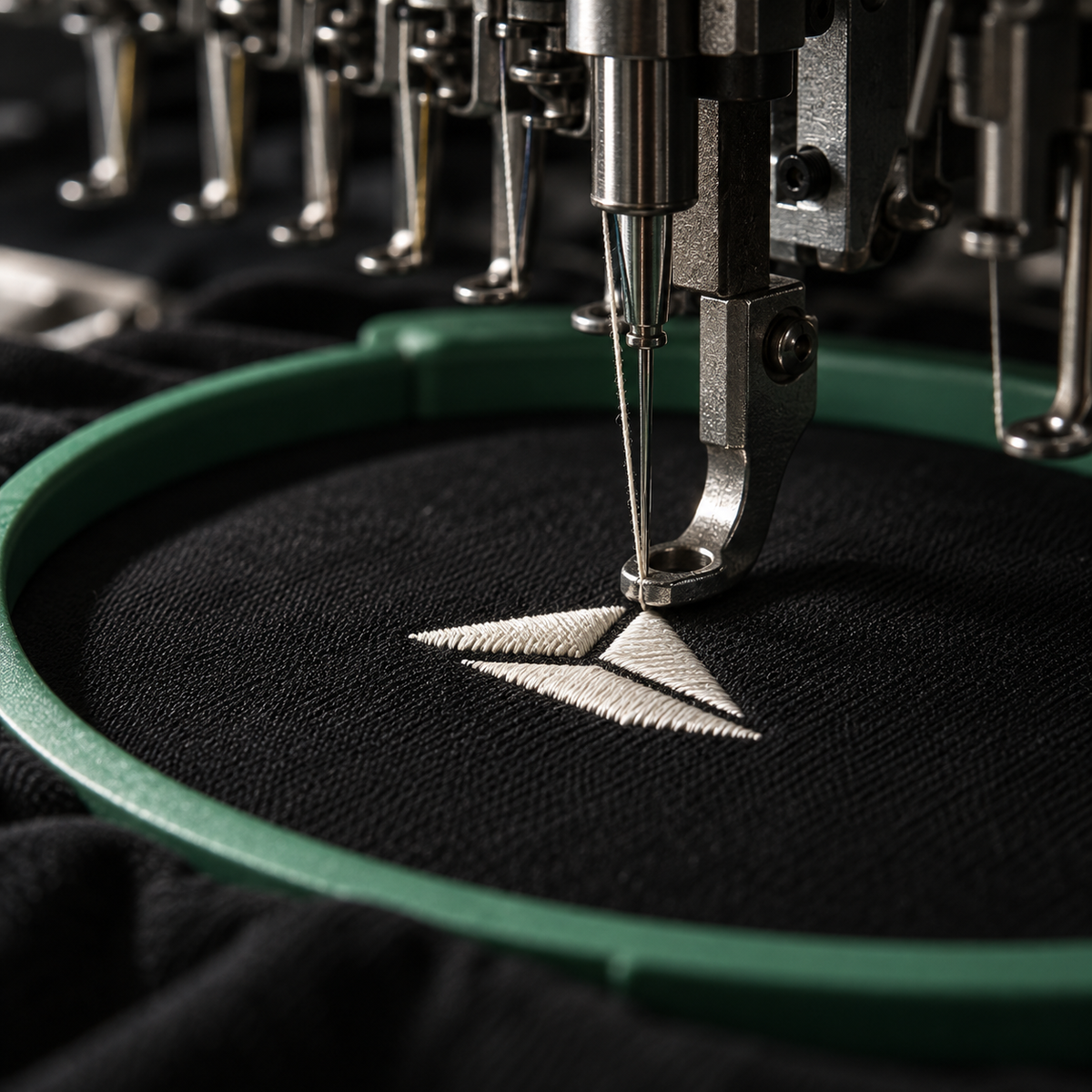 Close-up of precision embroidery stitching on black cotton